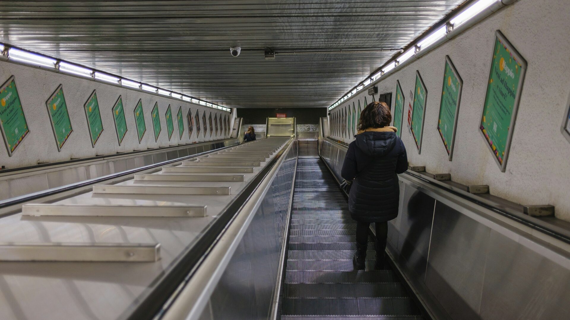 Woman using the escalator in a Rome metro station
