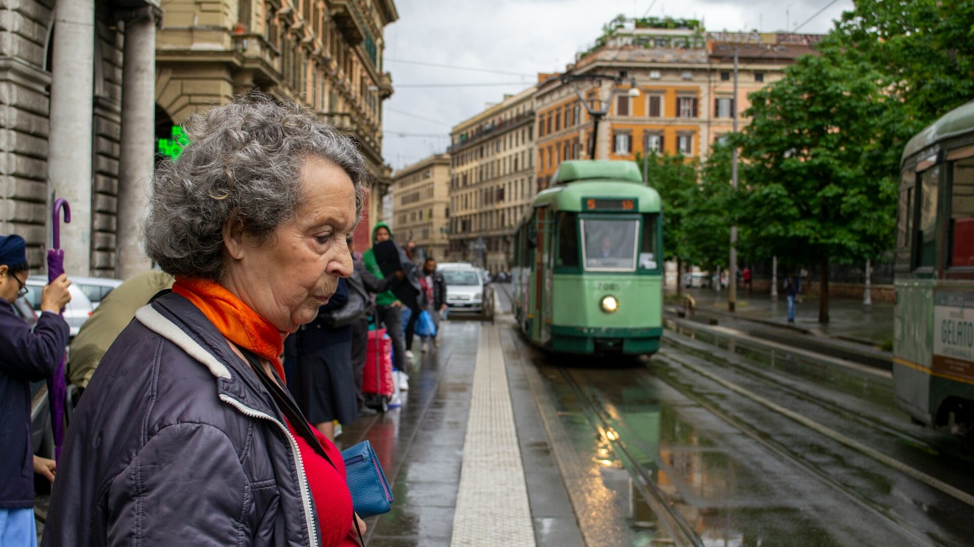 People waiting at a tram stop in Rome Italy