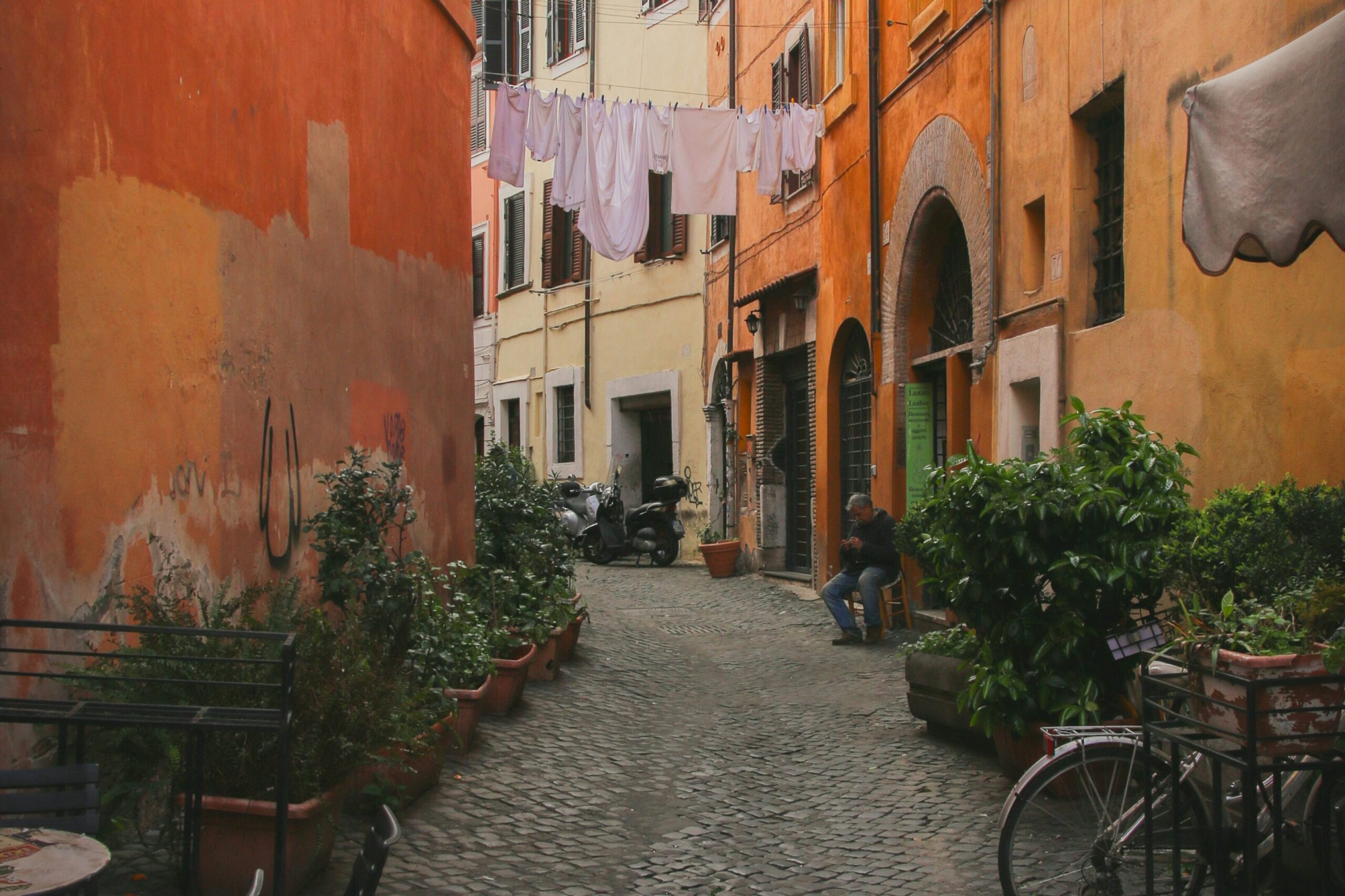 Cobblestone street in Trastevere with orange facades and historic buildings